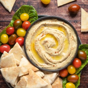 Baba ganoush in a black bowl topped with olive oil and smoked paprika.