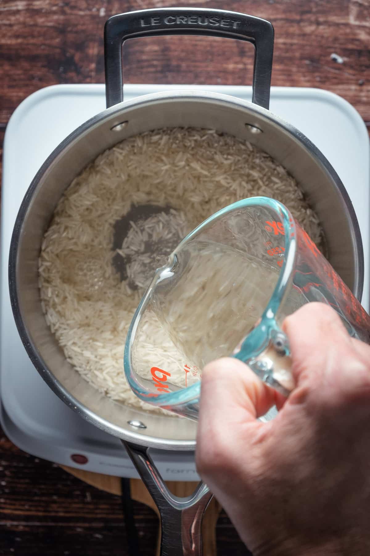 Water added to rice in pot.