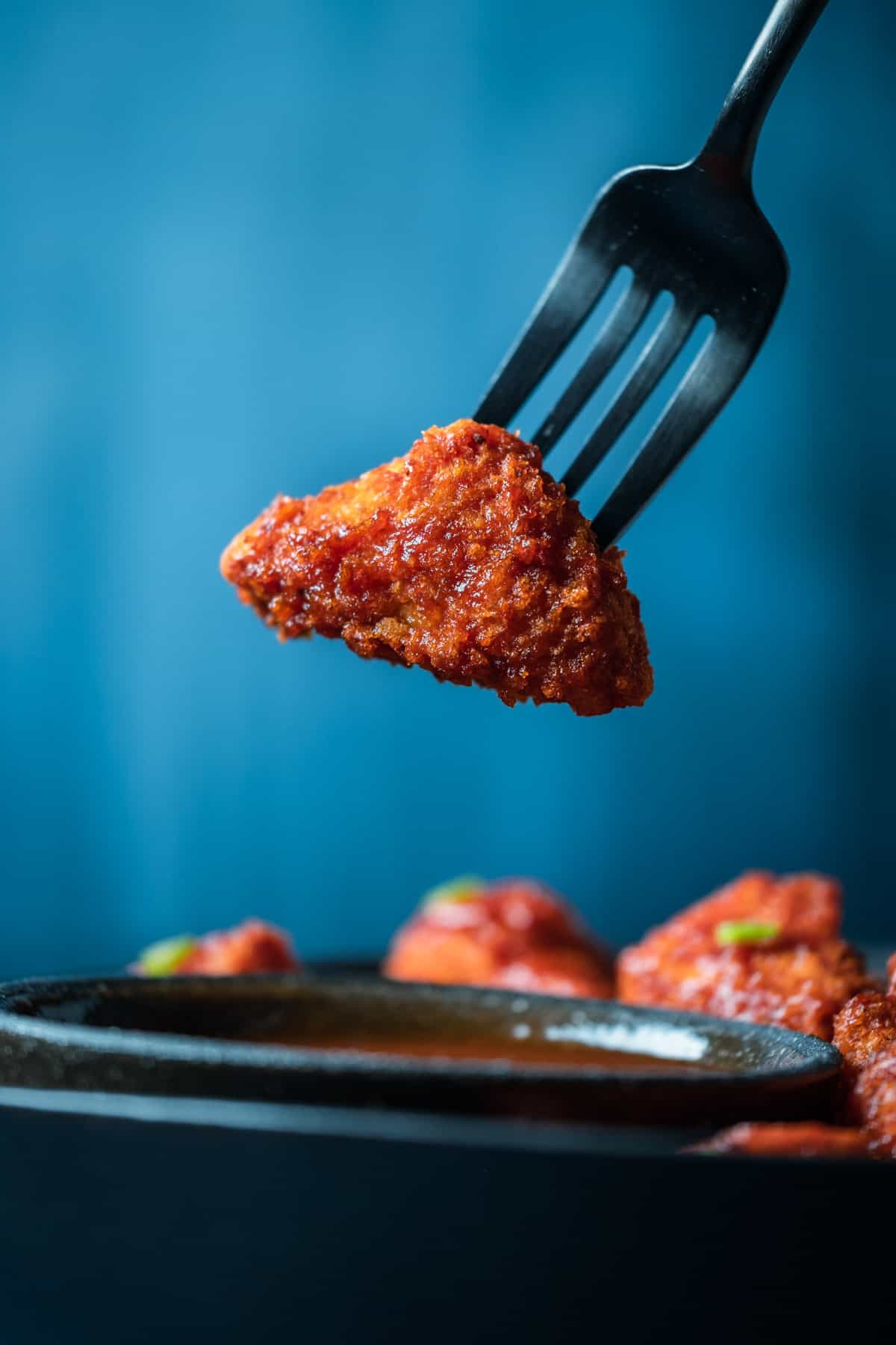 Piece of BBQ tofu on a fork.