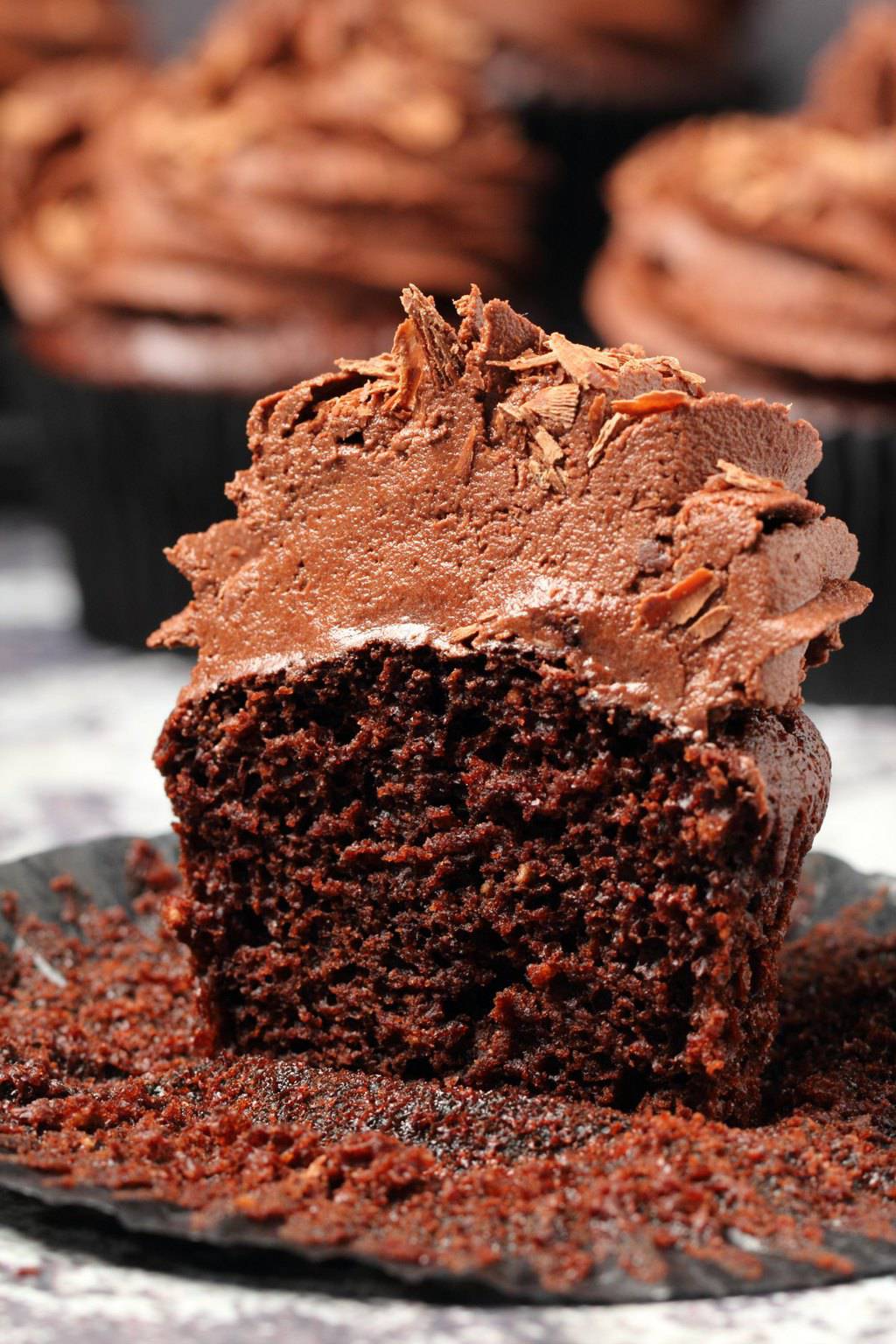 Classic vegan chocolate cupcake cut in half to show the center. 