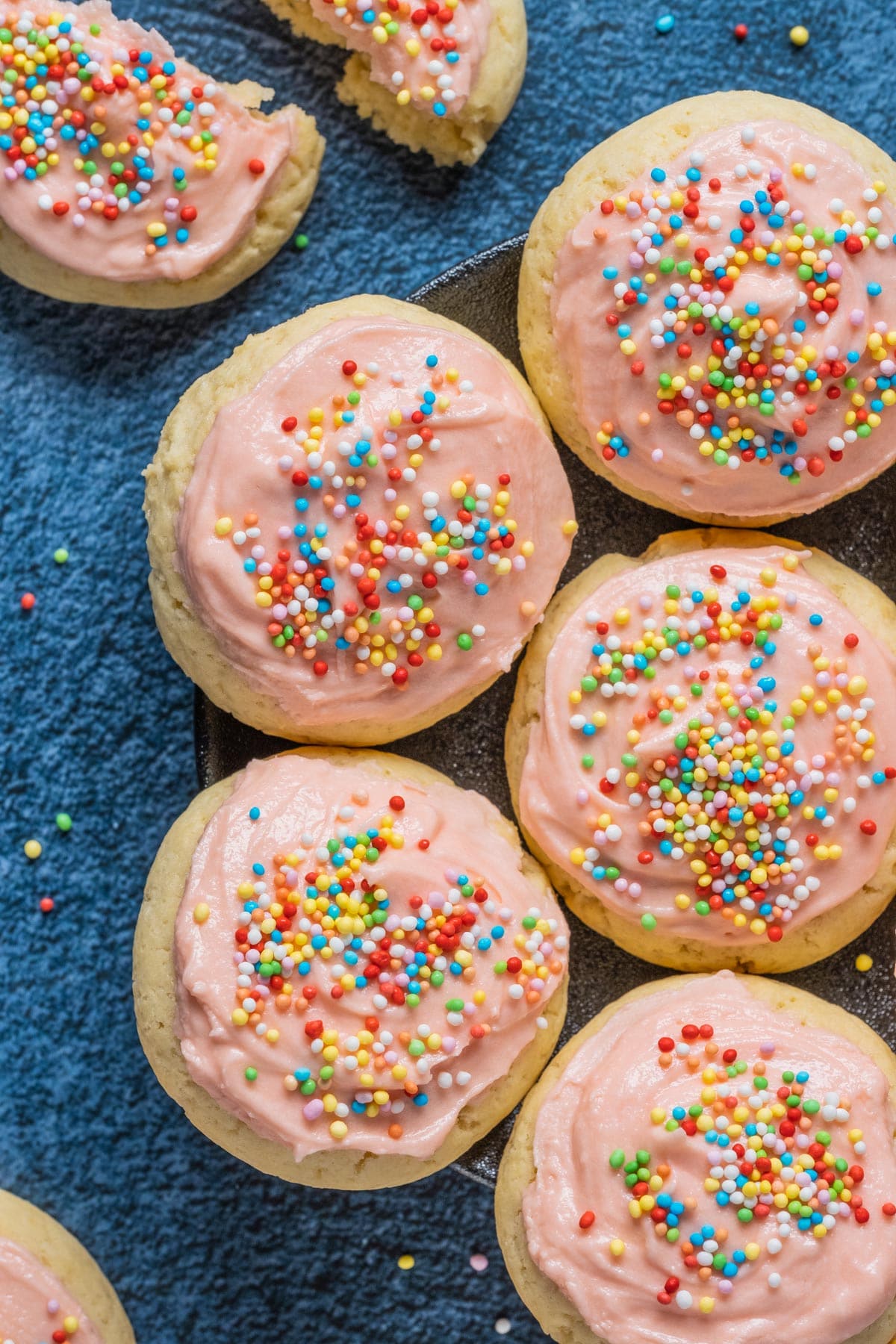 Frosted sugar cookies on a plate.