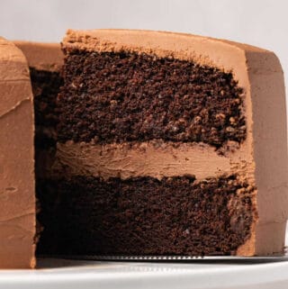 Gluten free chocolate cake on a white cake stand