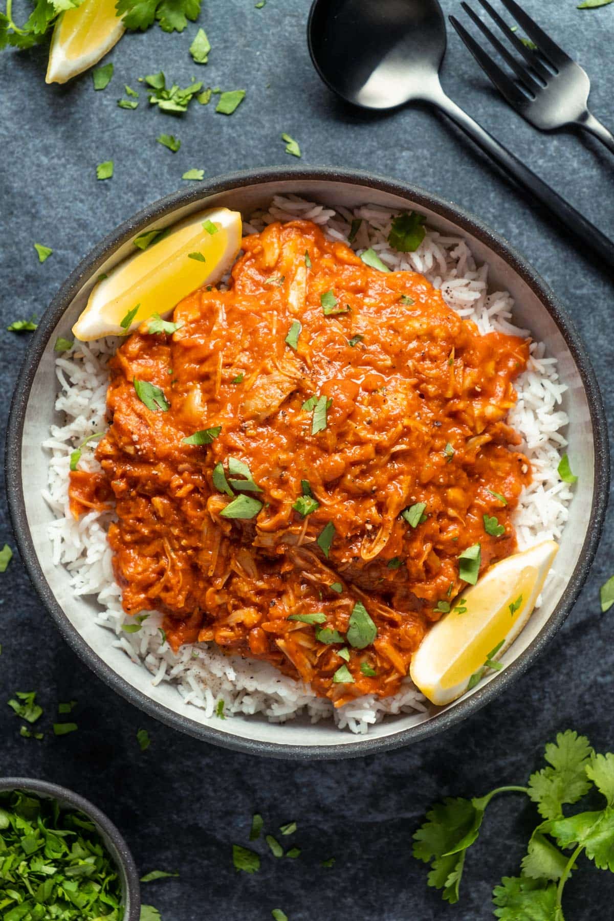 Jackfruit curry with rice in a black bowl. 