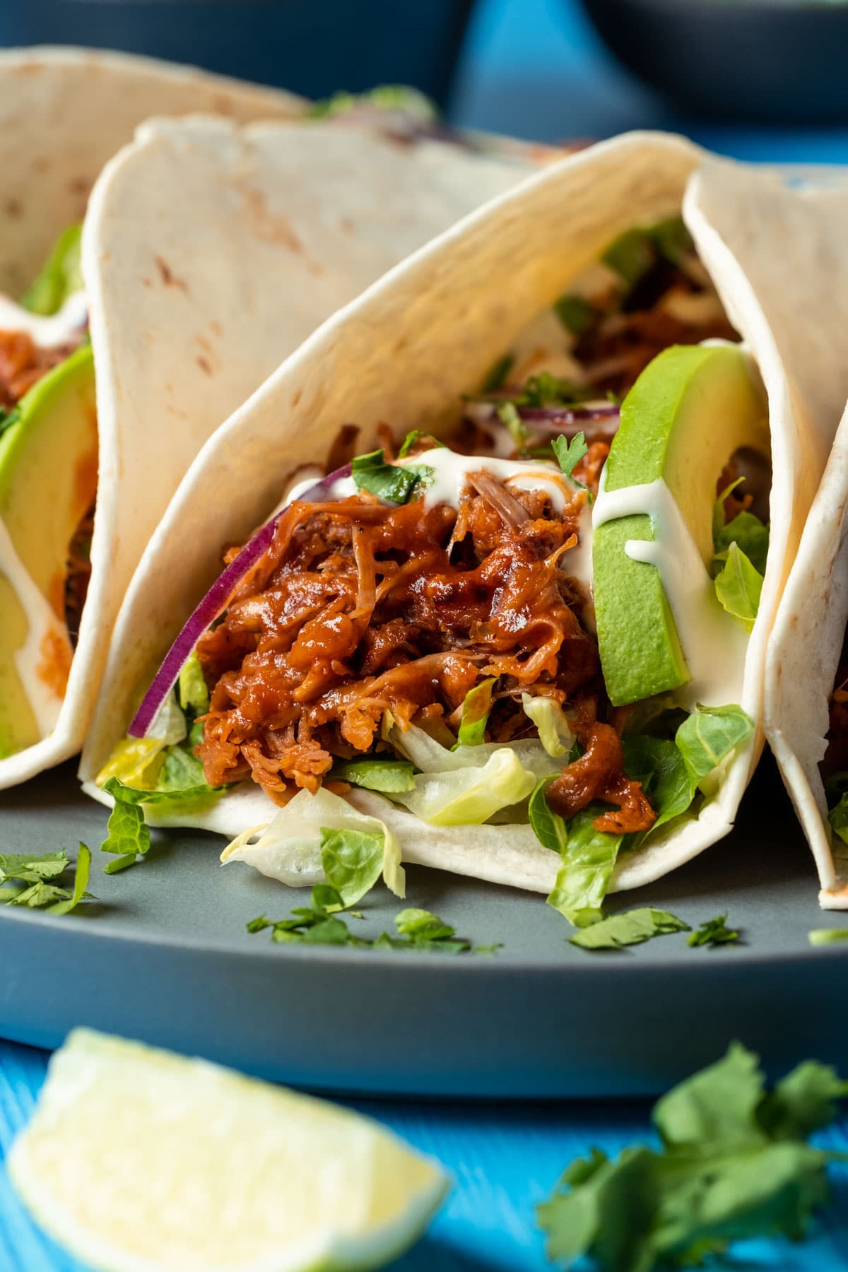 Jackfruit tacos on a gray plate. 