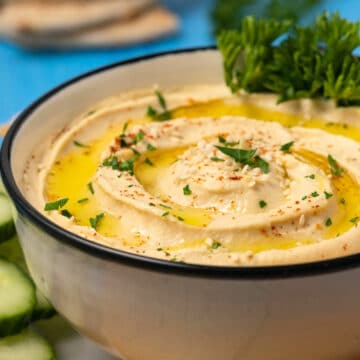 Roasted garlic hummus in a ceramic bowl.