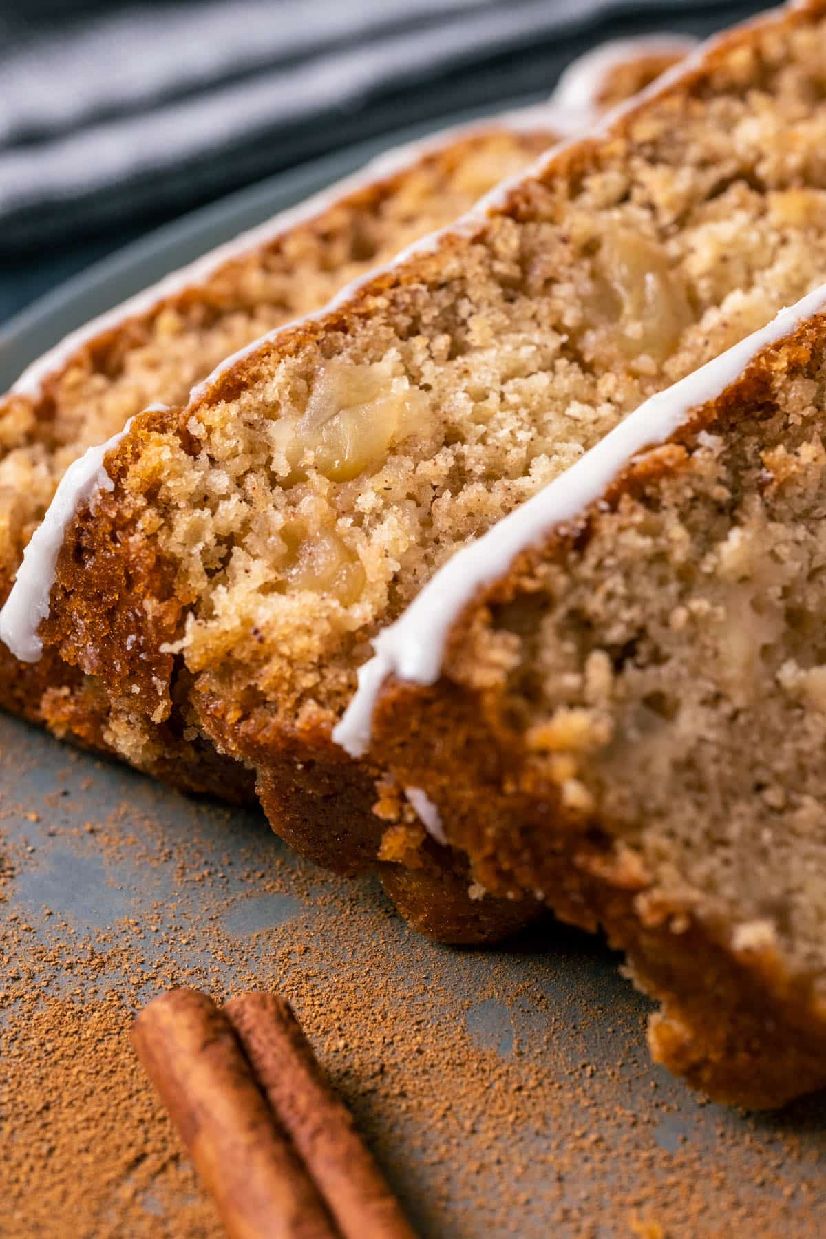 Vegan apple bread slices stacked on a gray plate