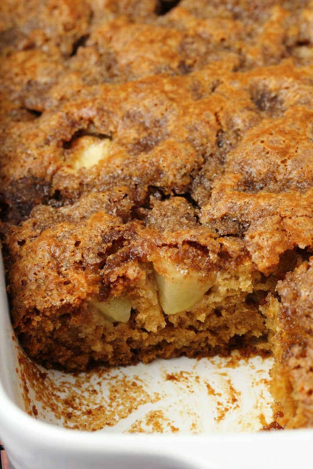 Vegan apple cake in a white glass dish. 