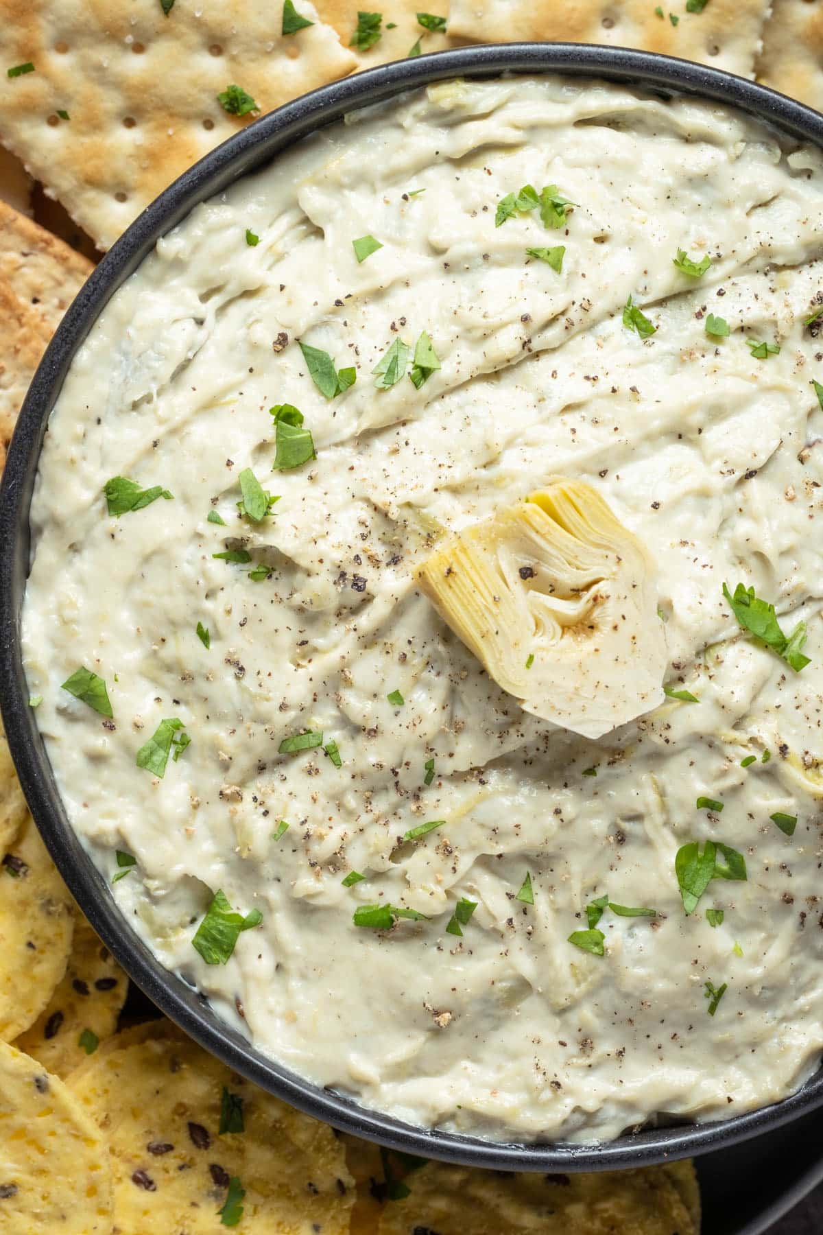 Vegan artichoke dip with crackers. 