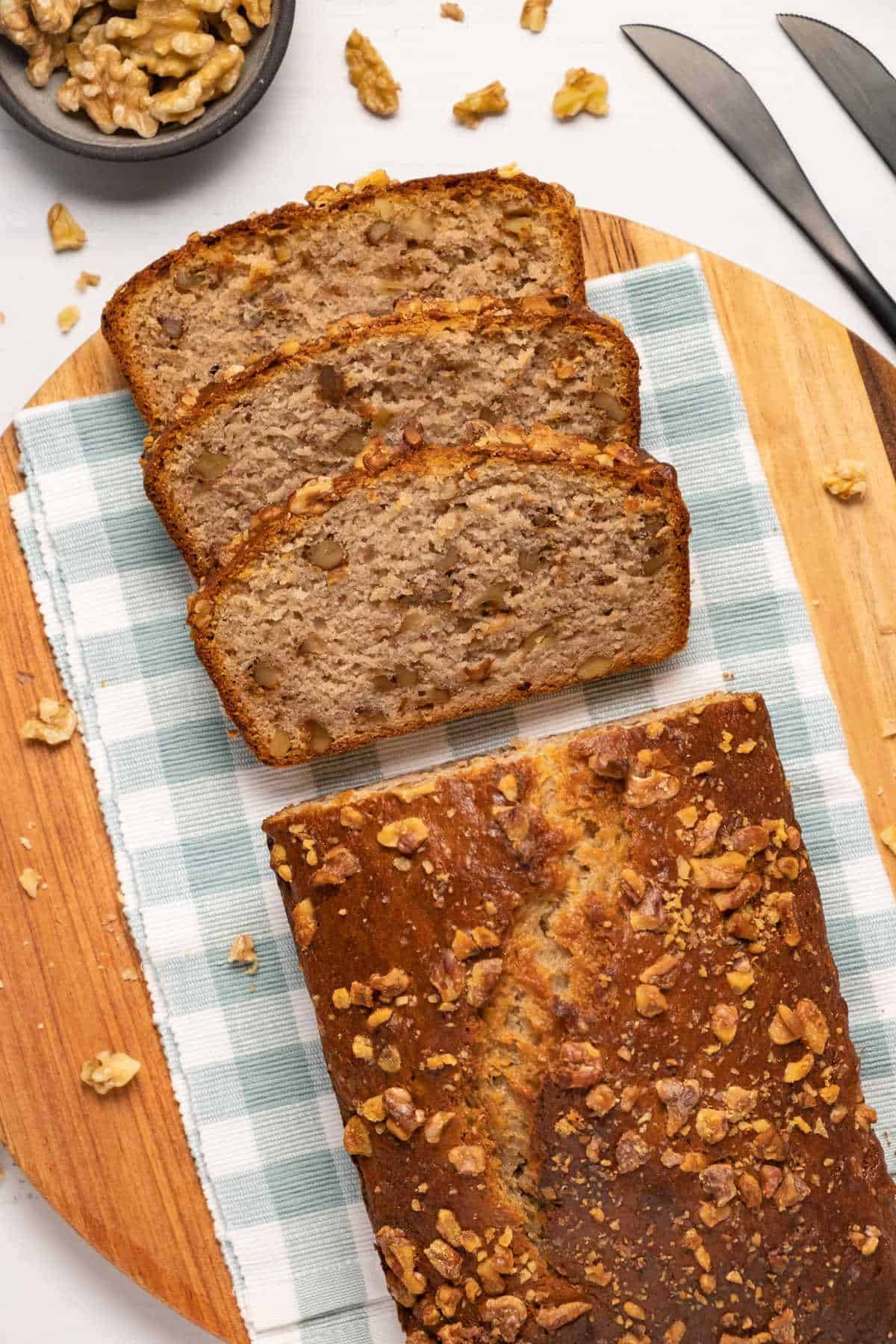 Sliced vegan banana bread on a cutting board