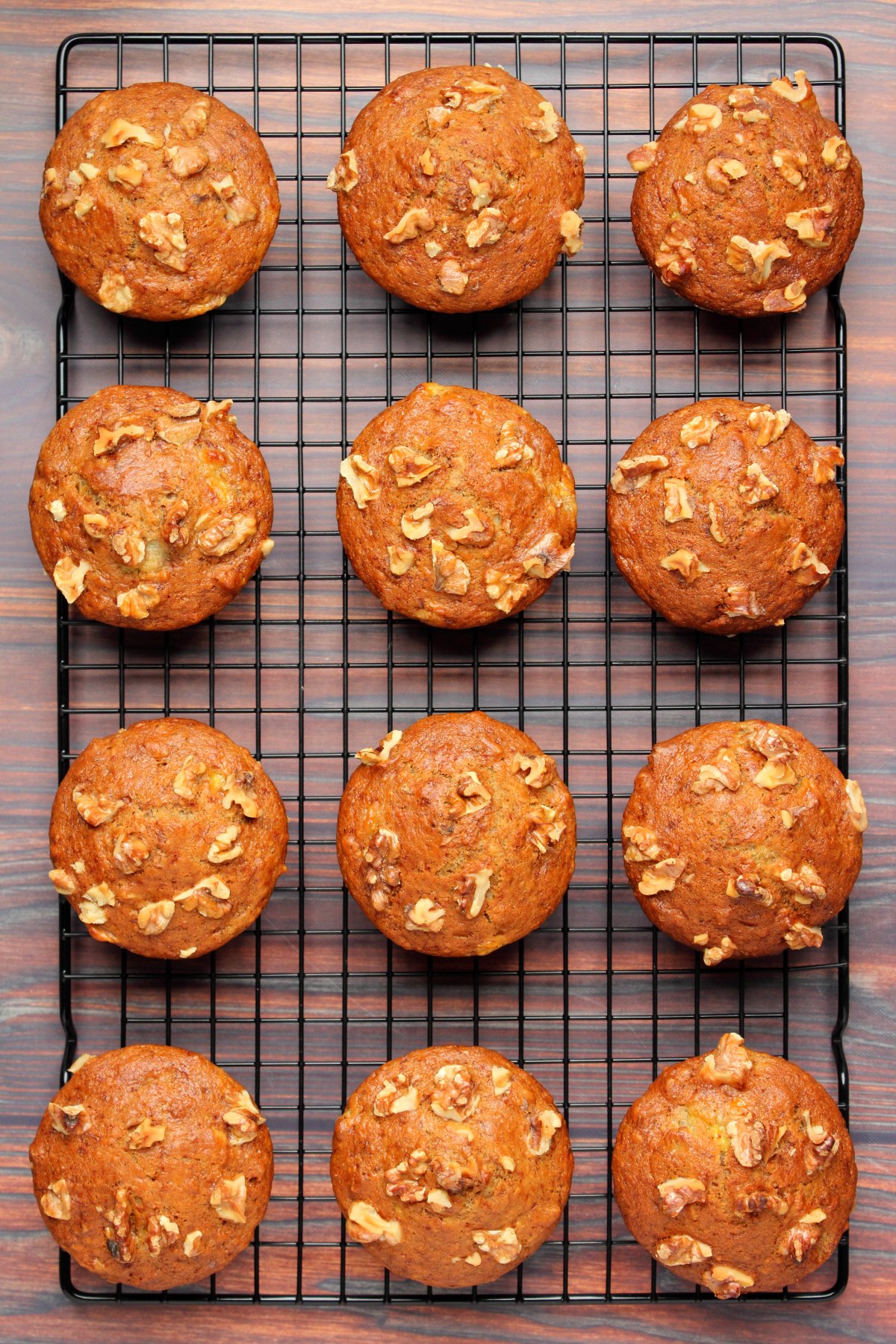 Vegan banana muffins cooling on a wire cooling rack.