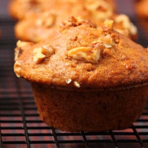 Vegan banana muffins on a wire cooling rack.