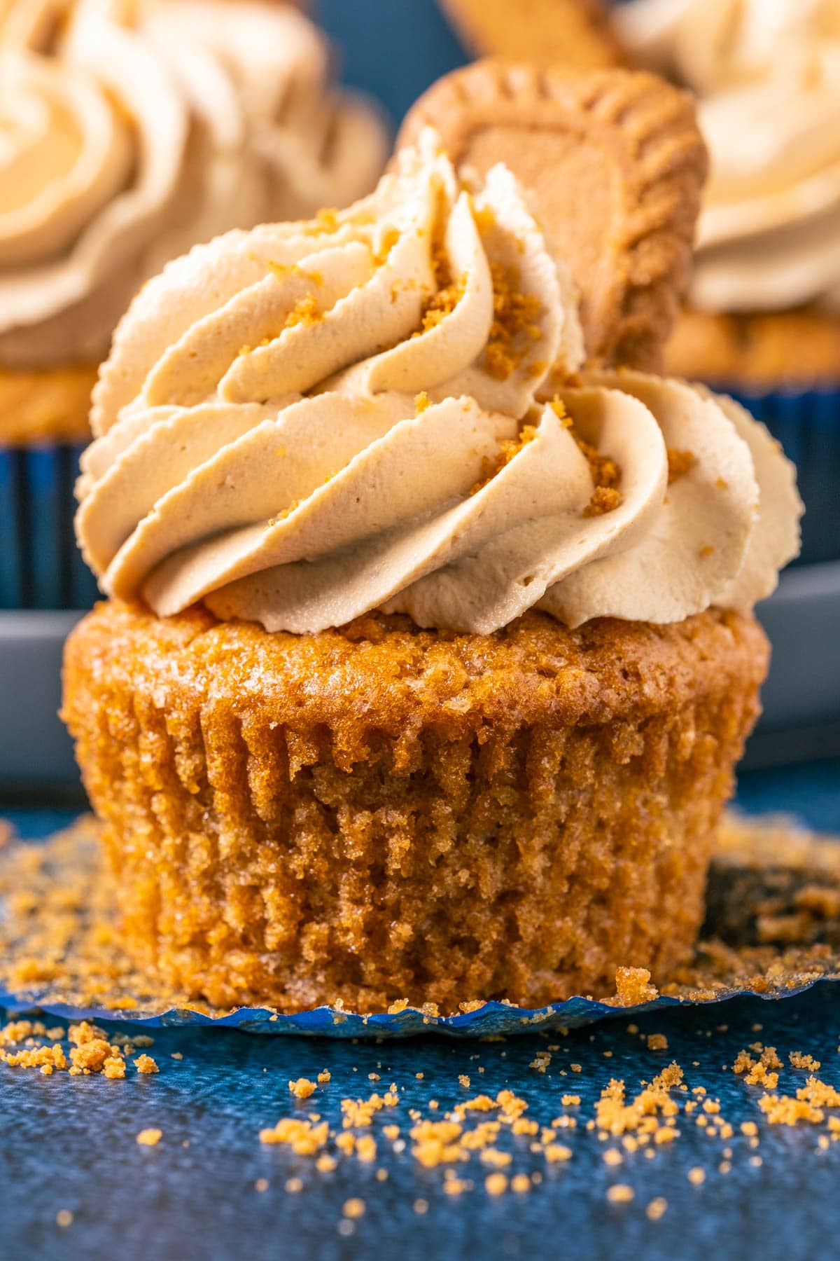 Vegan biscoff cupcake with the liner pulled down.