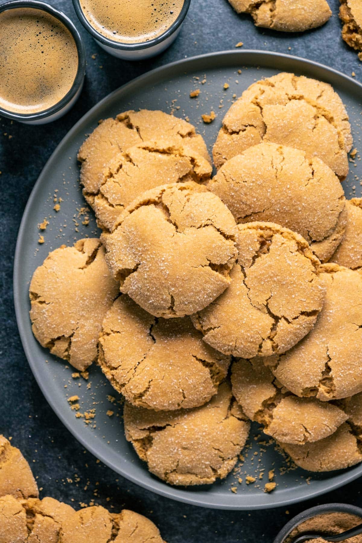 Vegan brown sugar cookies stacked up on a gray plate.