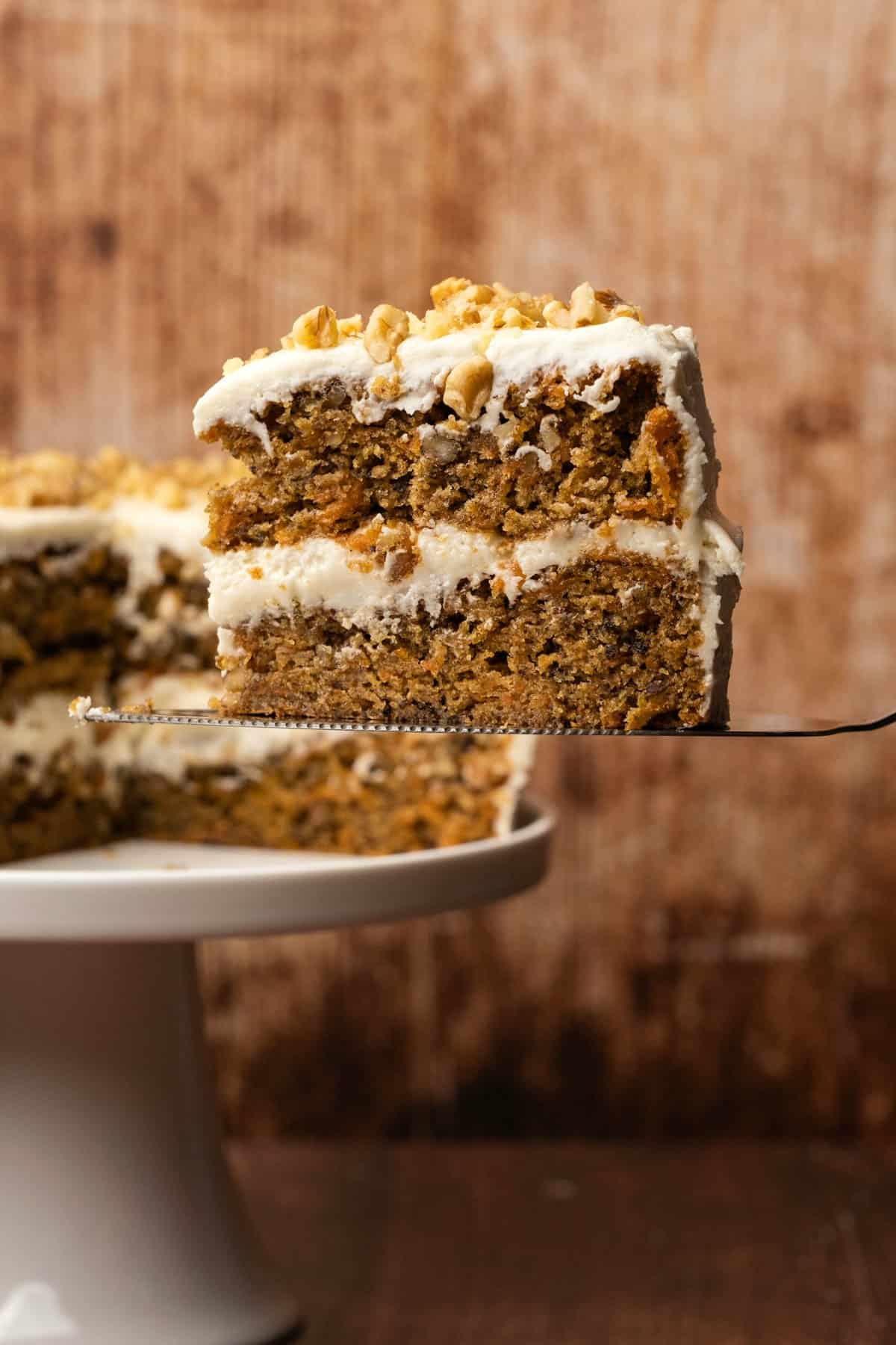 Slice of vegan carrot cake on a cake lifter. 