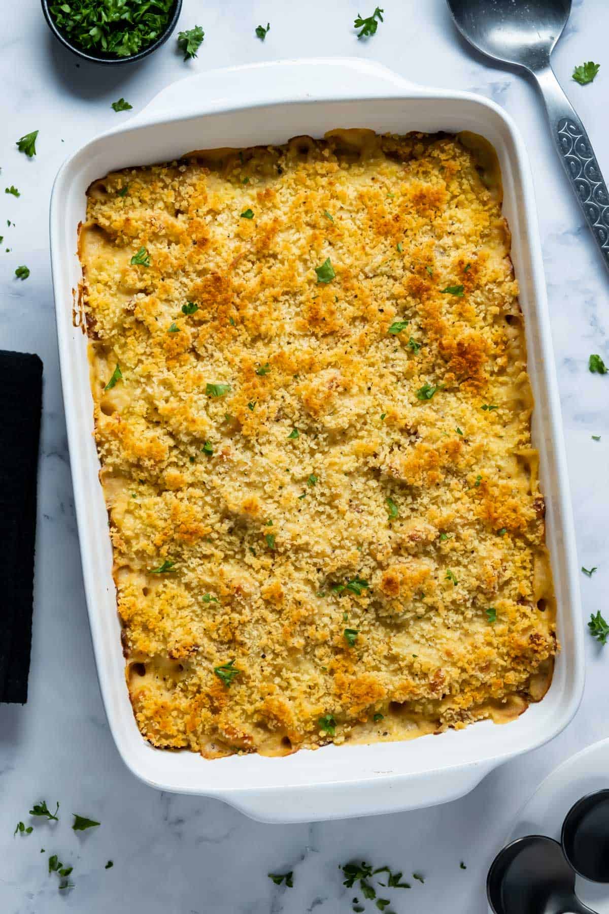 Vegan cauliflower cheese bake in a white baking dish.