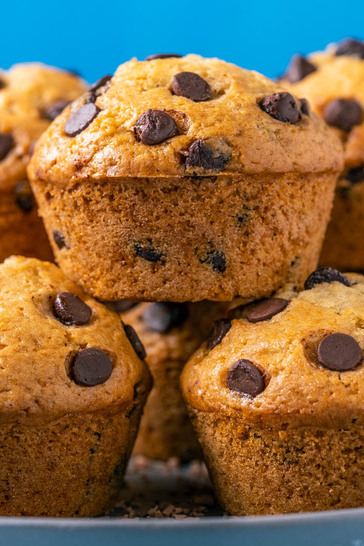 Stack of vegan chocolate chip muffins on a gray plate.