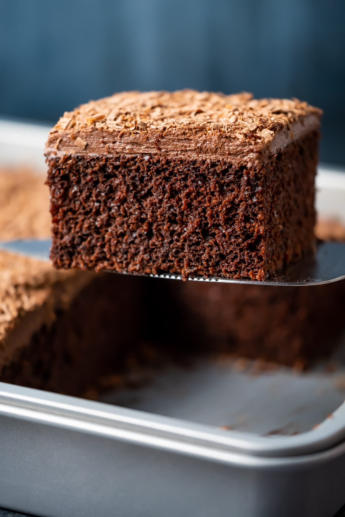 Slice of vegan chocolate sheet cake on a cake lifter.