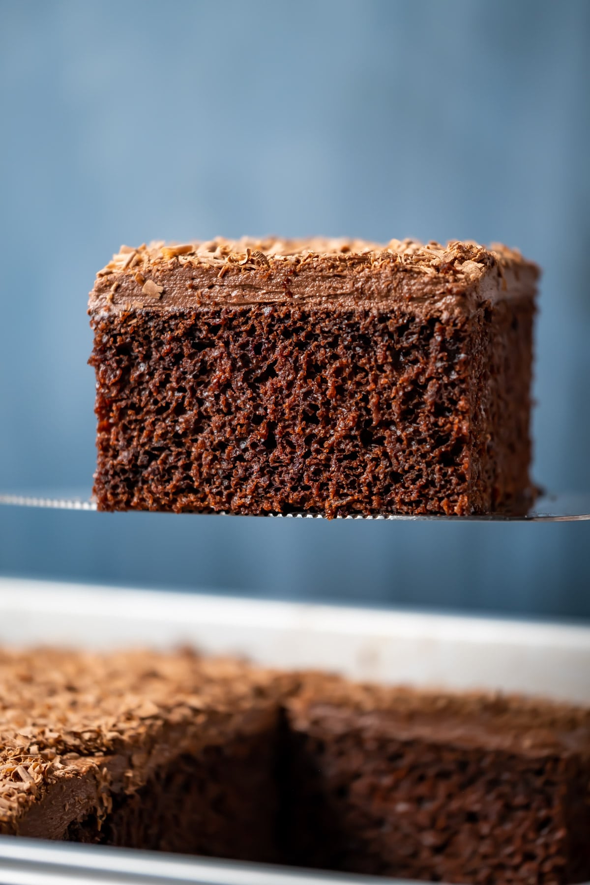 Slice of vegan chocolate sheet cake on a cake lifter.