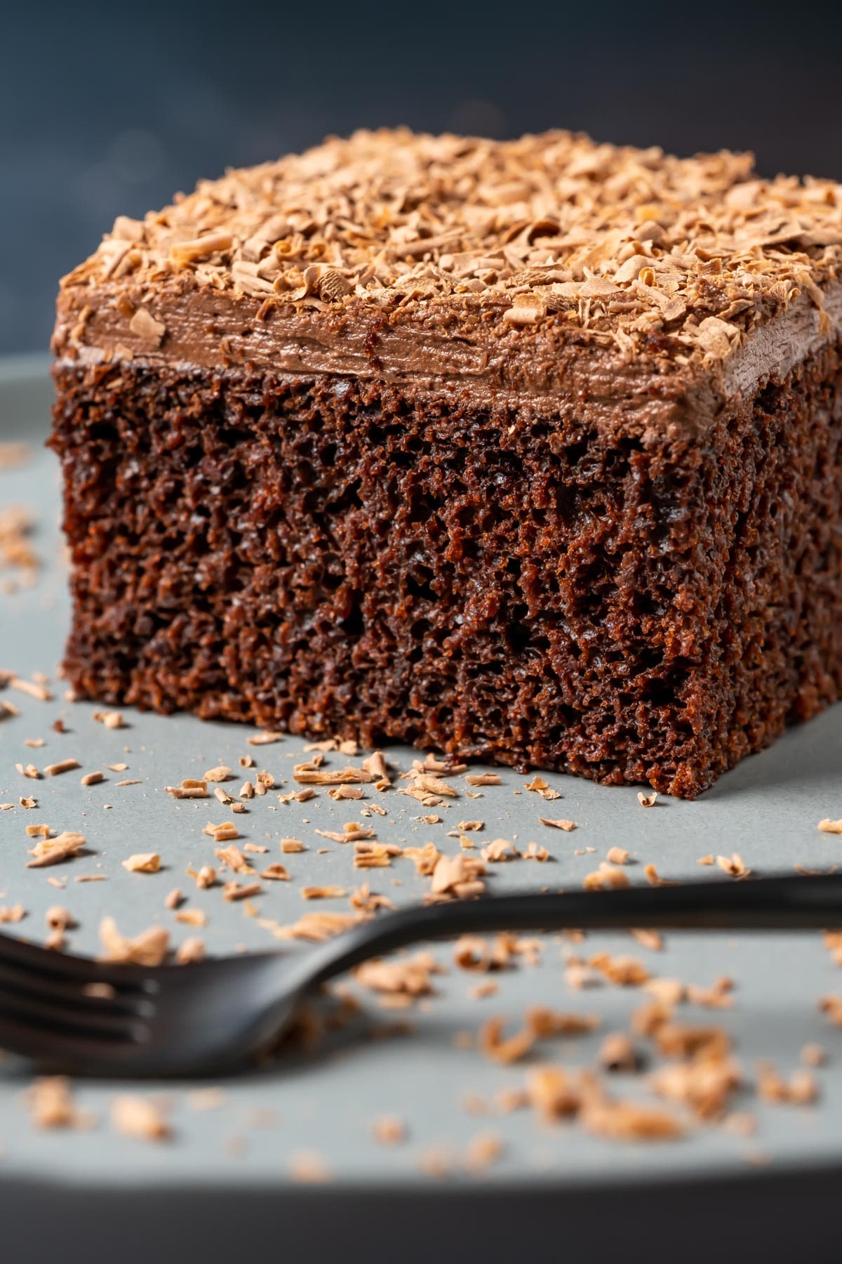 Slice of vegan chocolate sheet cake on a plate with a cake fork.