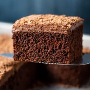 Slice of vegan chocolate sheet cake on a cake lifter.