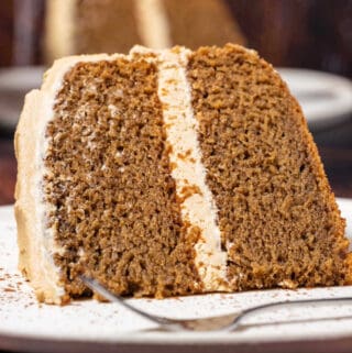 Slice of coffee cake on a white plate with a cake fork.