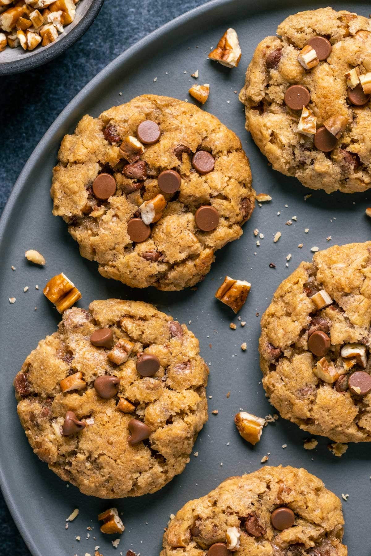 Homemade cowboy cookies on a gray plate.