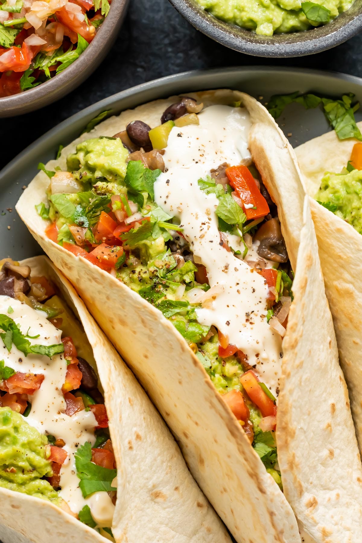 Fully loaded vegan fajitas on a gray plate. 