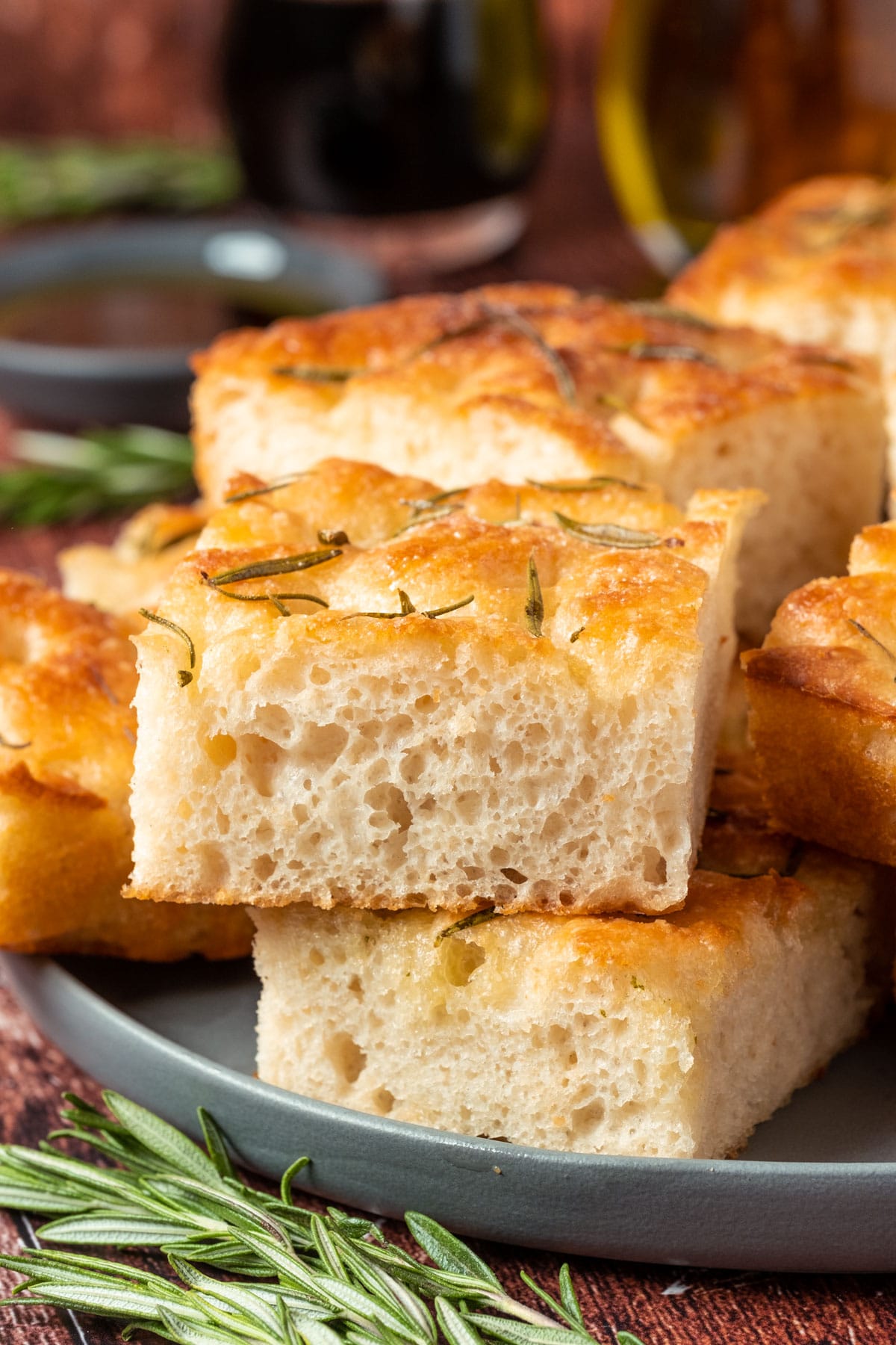 Vegan focaccia stacked up on a plate.