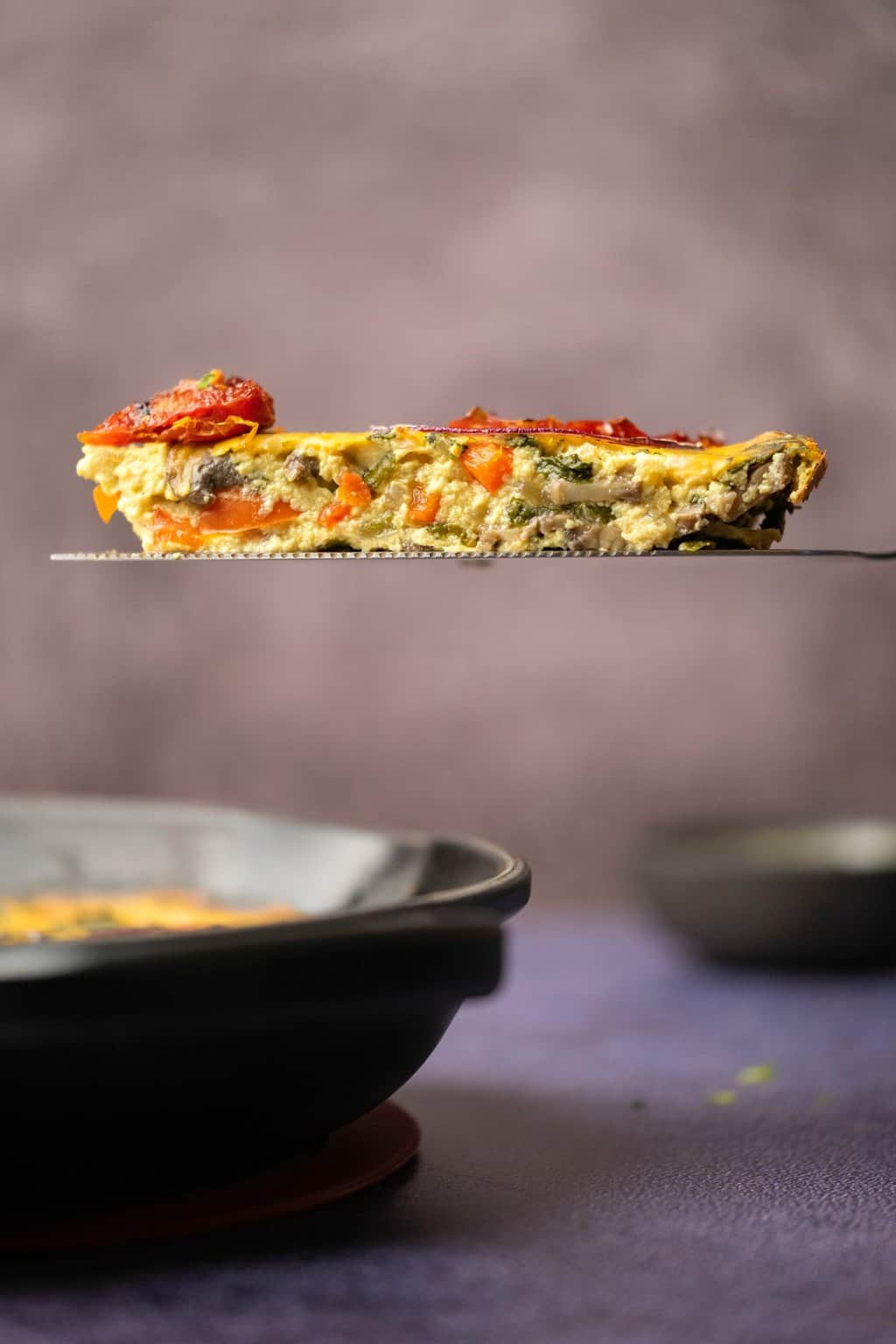 Slice of vegan frittata on a cake lifter. 