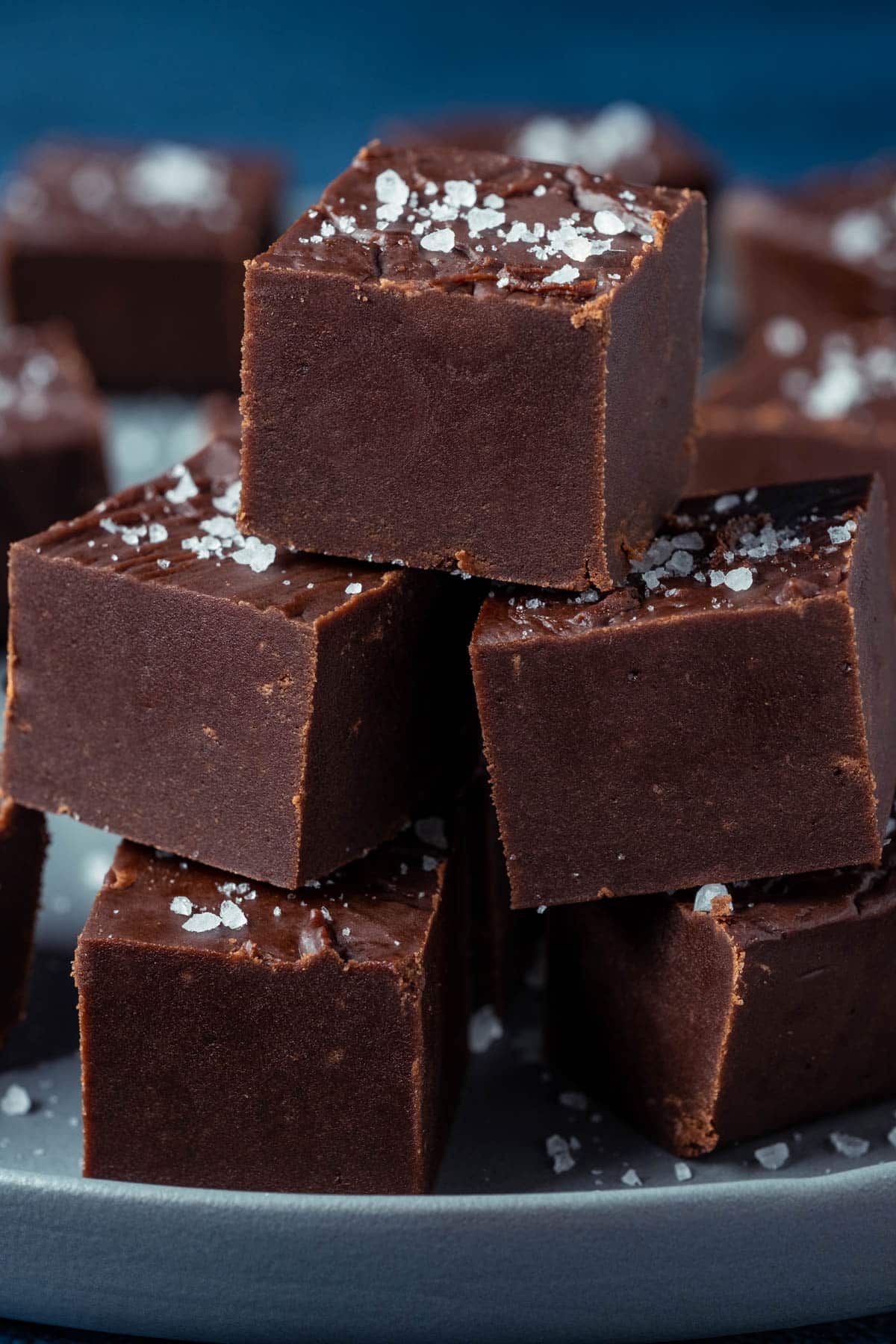 Vegan fudge stacked up on a gray plate. 