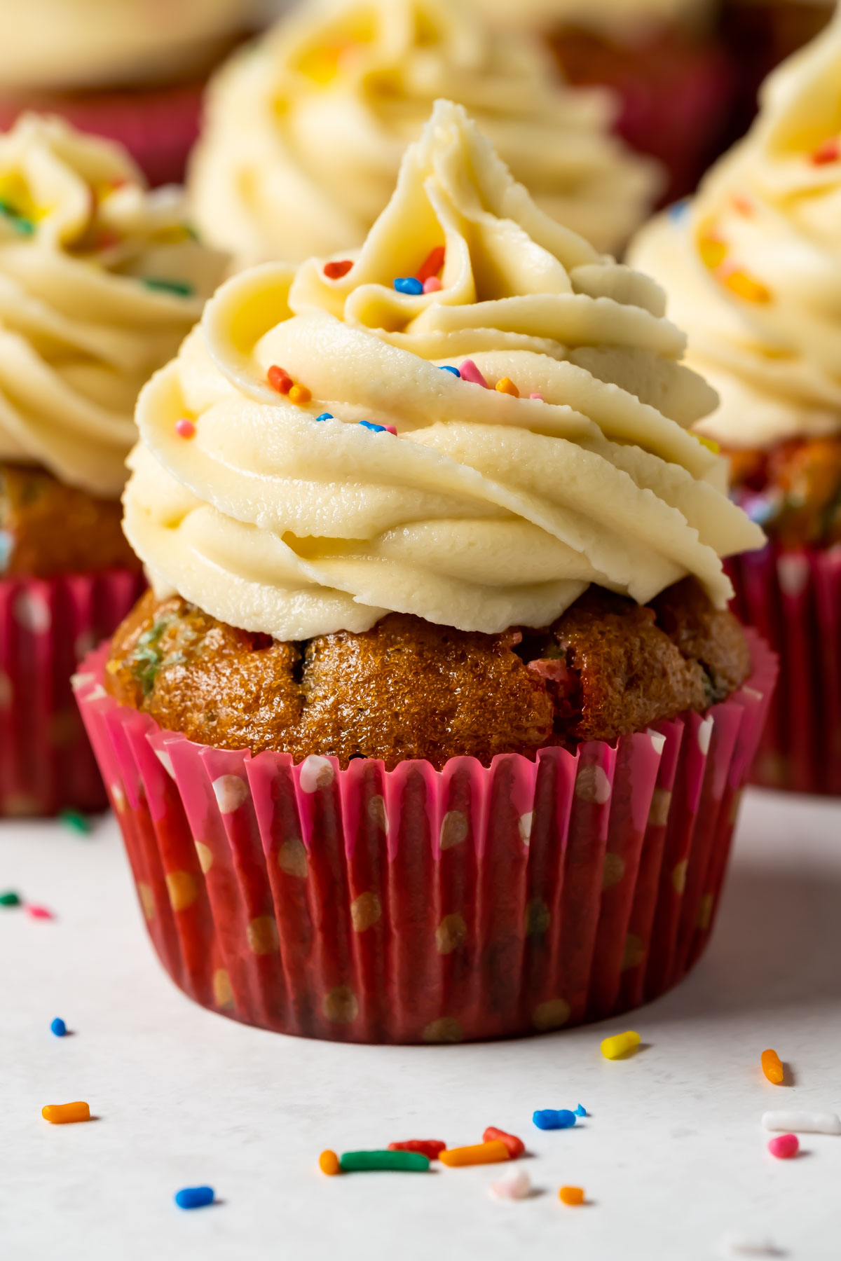 Vegan funfetti cupcakes on a white plate.