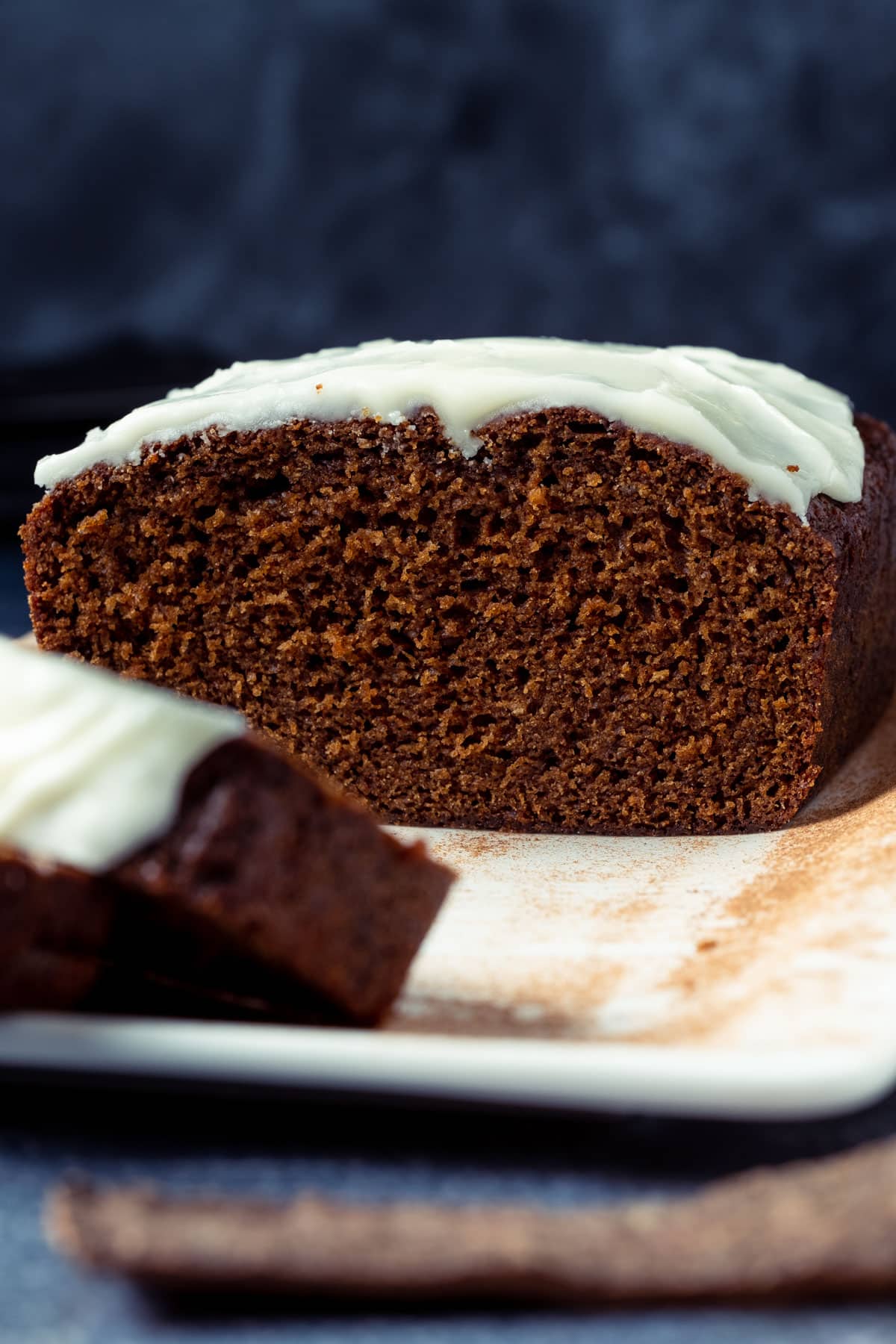 Sliced gingerbread loaf on a white plate.