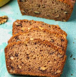 Vegan gluten free banana bread with three slices cut.