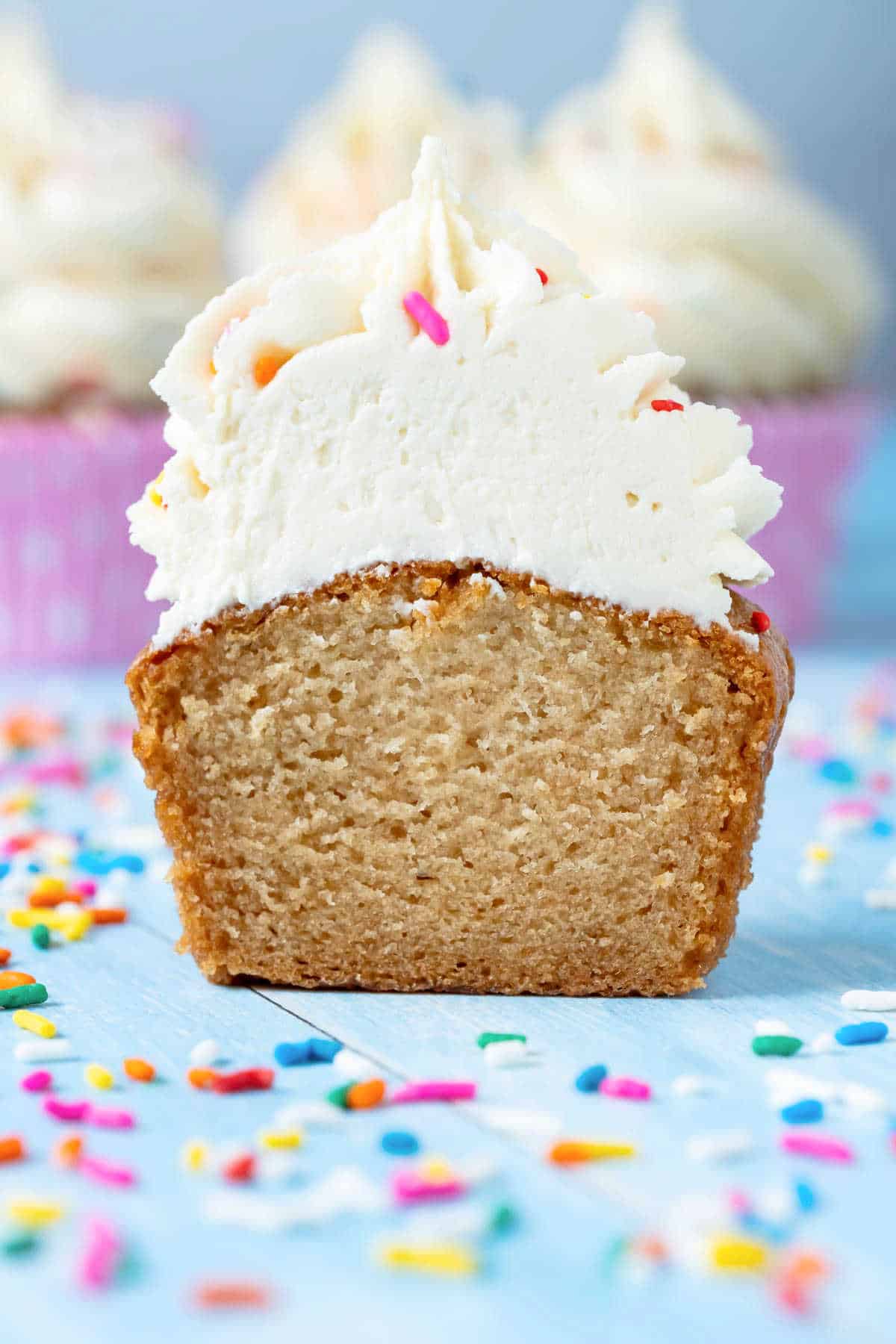 Vegan gluten free vanilla cupcake cut in half to show the center.