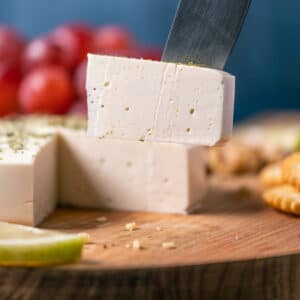 Slice of vegan goat cheese on a knife.