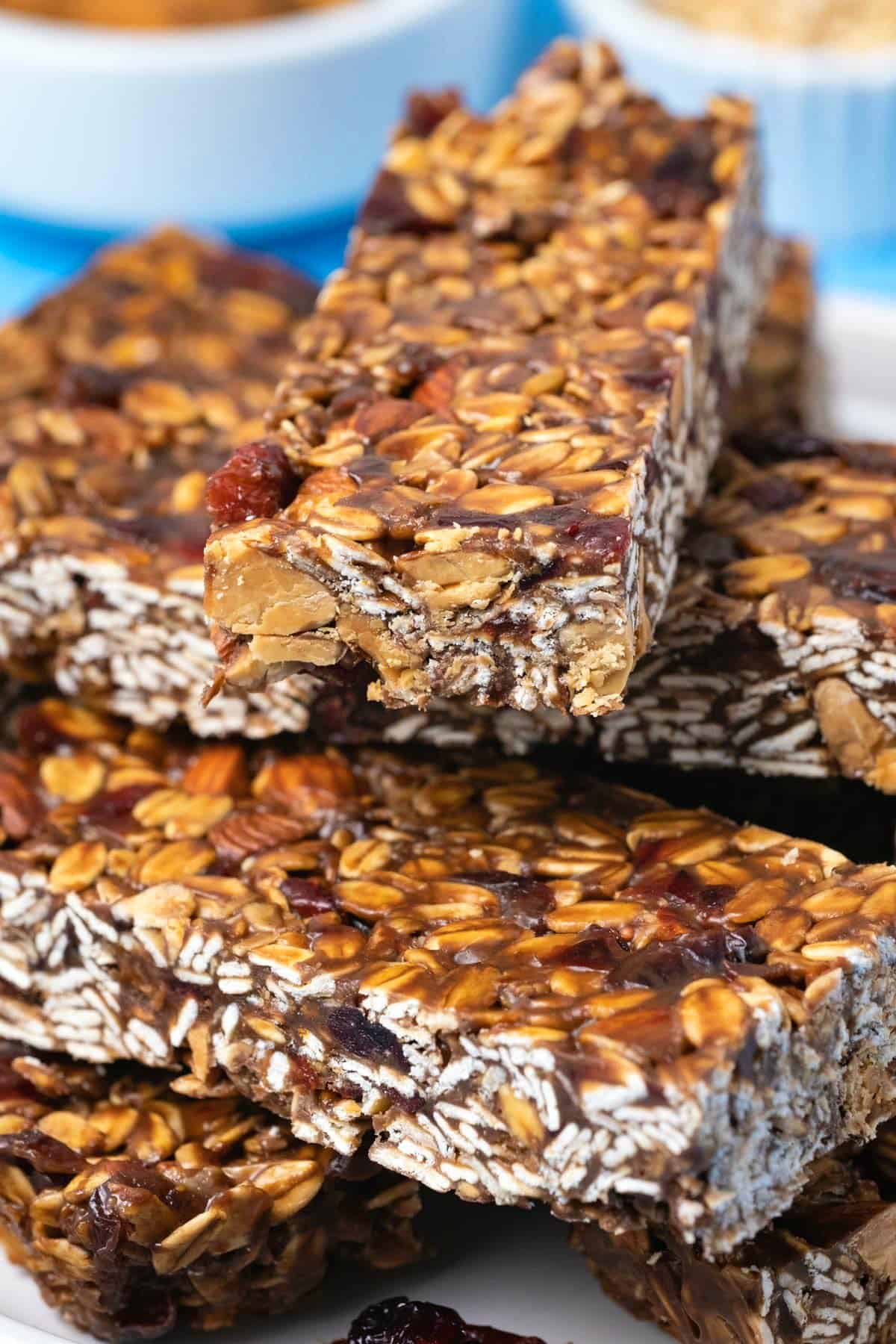 Granola bars stacked up on a white plate. 