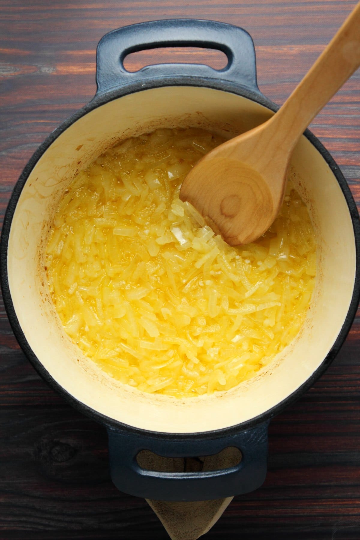 Onions and vegan butter sautéed together in a pot. 