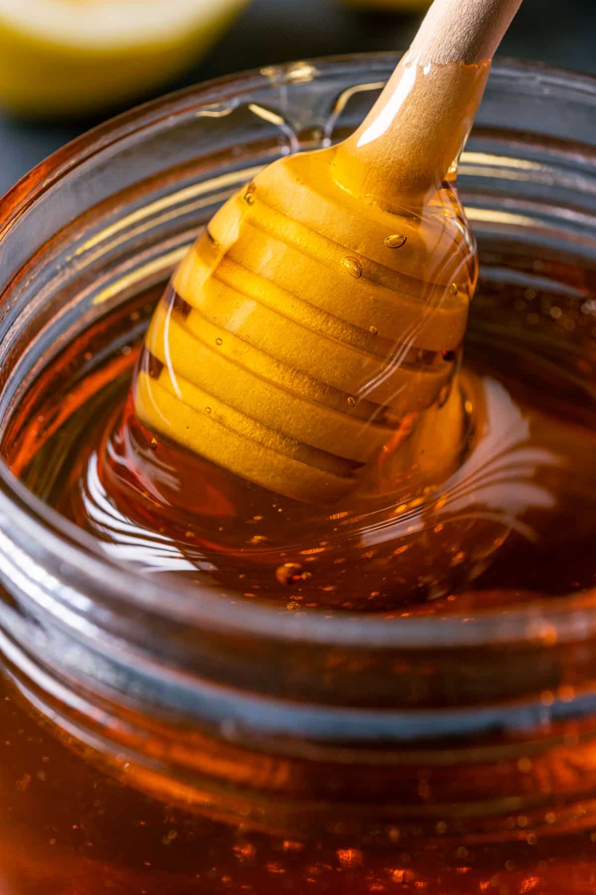 Vegan honey in a jar with a honey dipper.