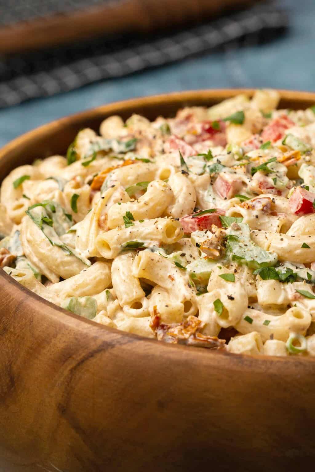 Vegan macaroni salad in a wooden salad bowl. 