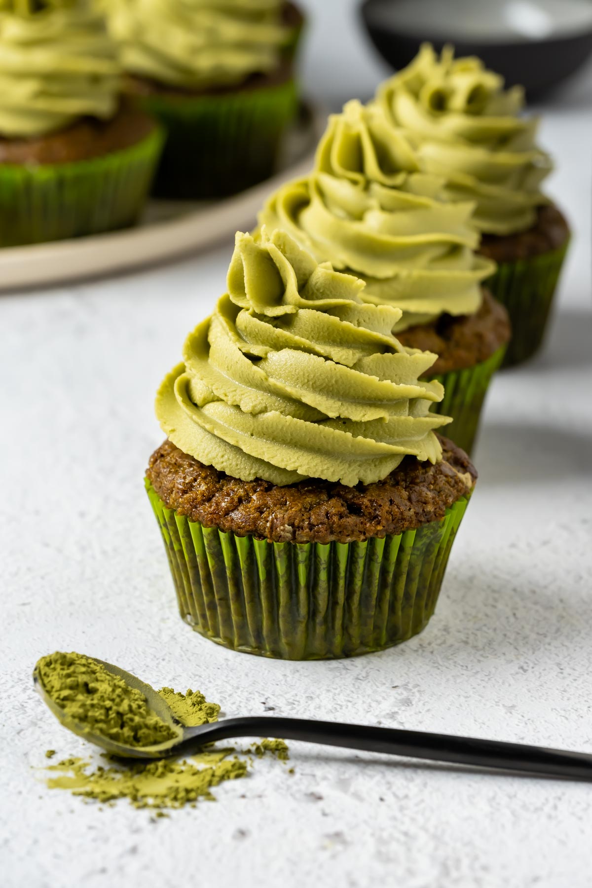 Vegan matcha cupcakes in a row.