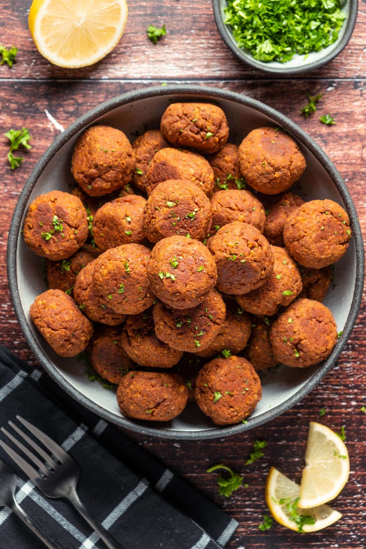 Vegan meatballs stacked up on a plate. 