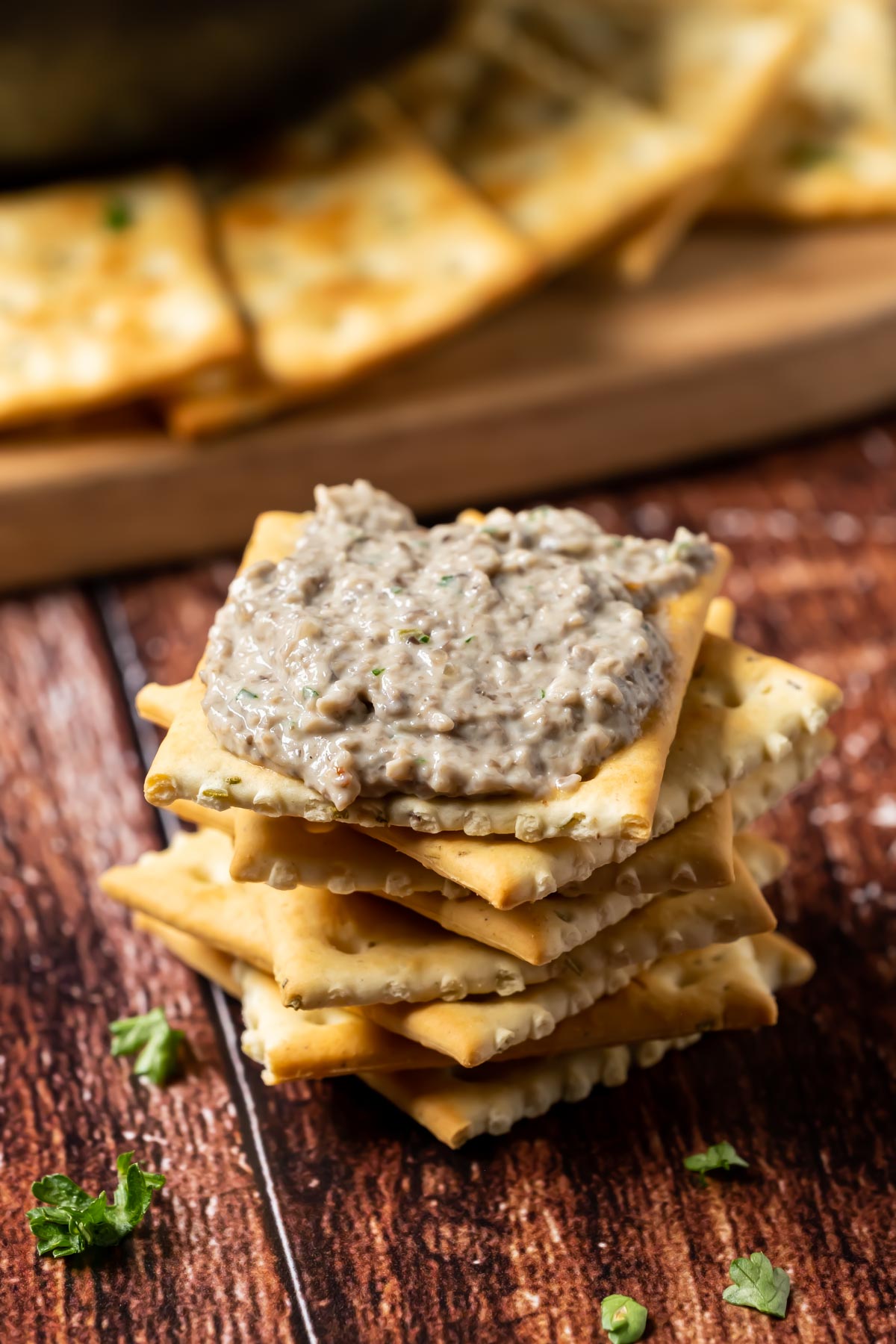 Vegan mushroom pâté on a stack of crackers.