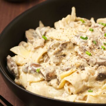 Vegan mushroom stroganoff in a black bowl.