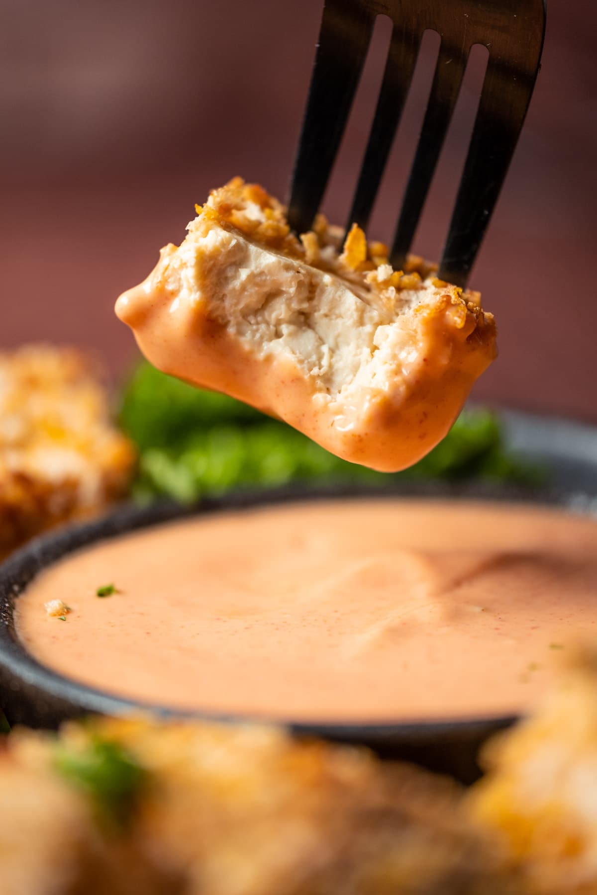 Vegan chicken nugget dipped in yum yum sauce.