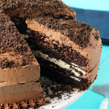 Vegan Oreo cake on a white cake stand.