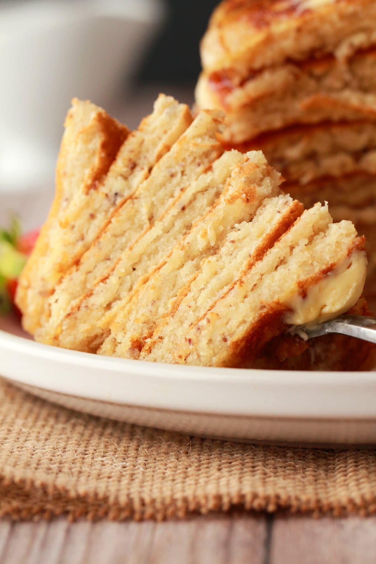 Forkful of vegan pancakes on a plate. 