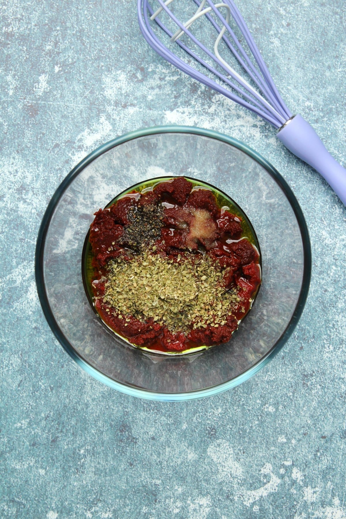 Tomato sauce ingredients added to mixing bowl.