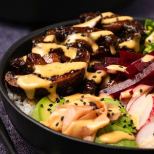 Vegan poke bowl drizzled with spicy mayo.