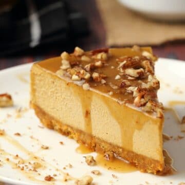 Slice of vegan pumpkin cheesecake on a white plate.