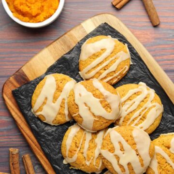 Vegan pumpkin cookies on black tissue paper.